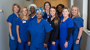 Nurses and doctors standing together smiling